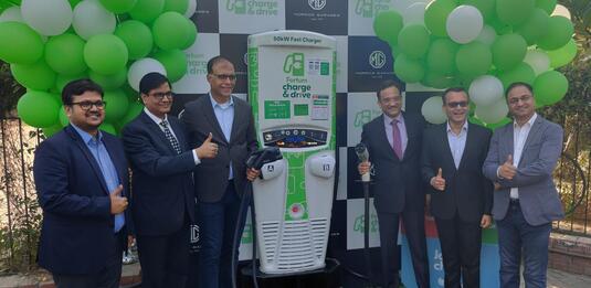 Six men at a Fortum and MG EV charging station opening in India